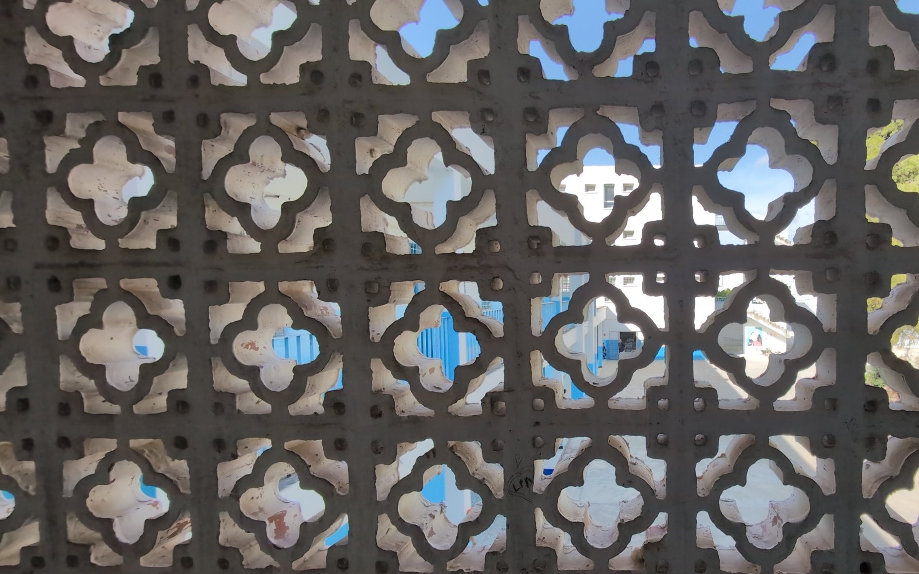 The courtyard seen through the school's carved stone screen